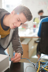 Businessman plugging in printer in office