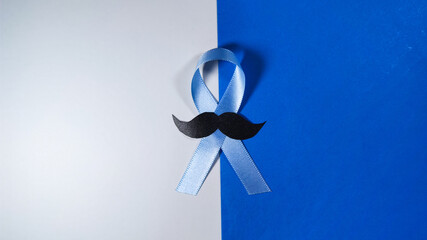 November Prostate Cancer Awareness month. Blue Ribbon with mustache for supporting people living...