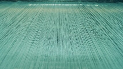 Lots of coloured threads in the weaving process