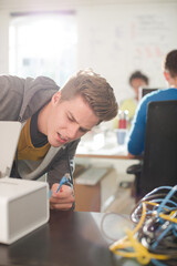 Businessman plugging in printer in office