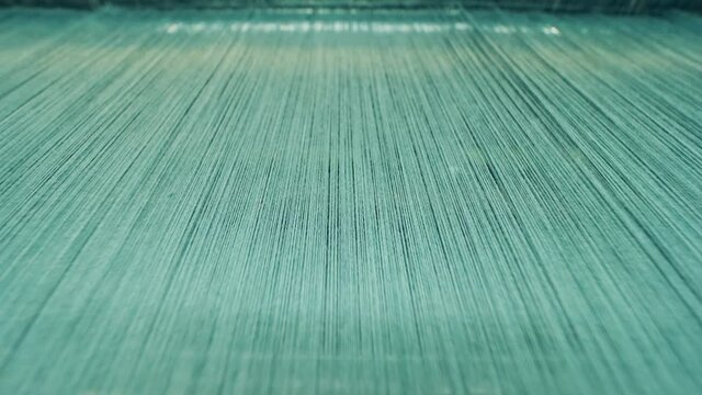 Lots of coloured threads in the weaving process