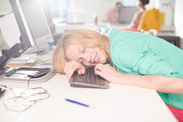Businesswoman sleeping at desk