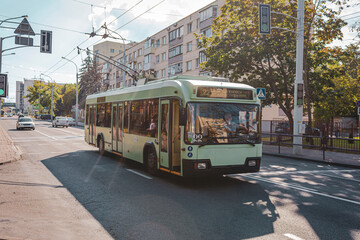 Fototapeta na wymiar A trolleybus rides along a summer street in Minsk