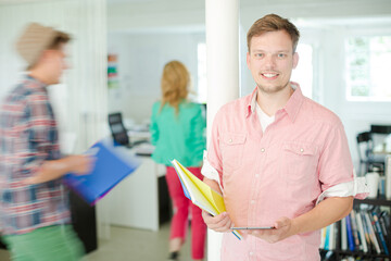Fototapeta premium Businessman carrying folders in office