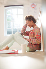 Businesswoman sitting on floor in office