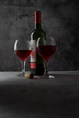 Fototapeta na wymiar red wine poured into a glass on a dark background