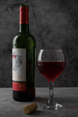 red wine poured into a glass on a dark background