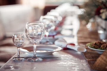 Decorated elegant wooden wedding table for banquet outdoor in garden gazebo