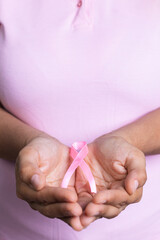 woman holding pink ribbon in her hands, breast cancer, white background