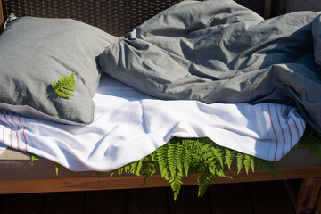 Wood Fern leaves under bedsheet. Sleeping on fern leaves. Tradicional anti-arthritic remedy.