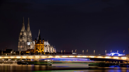 Ancient buildings next to Rhine river illuminated in German city Cologne
