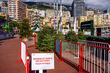 This image shows a coronavirus COVID-19 social distancing sign at the entrance to the skating rink, requiring to wear face covering protective masks and gloves for skating in Monte Carlo, Monaco