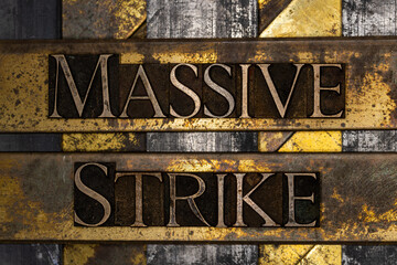 Massive Strike text message on textured grunge copper and vintage gold background