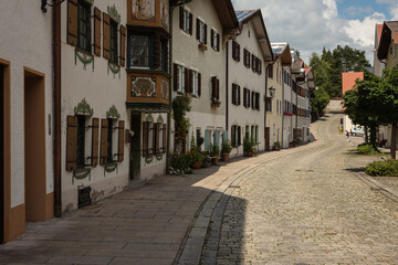 Fototapeta na wymiar Street with traditional houses in old town of Füssen, Bavaria, Germany