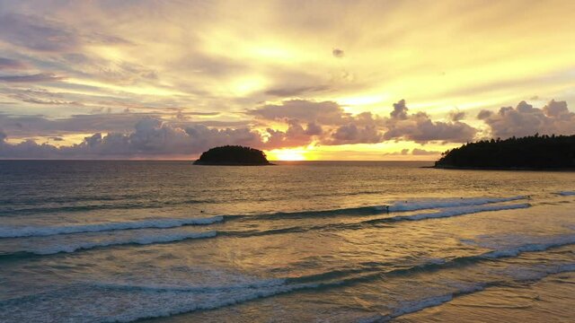 aerial view Scene of Colorful romantic sky sunset with Changing the color of the sky background. .beautiful golden sky at sunset over Pu island at Kata beach Phuket in nature and travel concept.