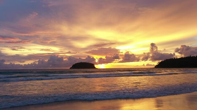 aerial view Scene of Colorful romantic sky sunset with Changing the color of the sky background. .beautiful golden sky at sunset over Pu island at Kata beach Phuket in nature and travel concept.