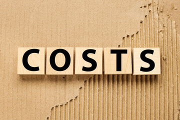 Costs, wooden blocks on craft background from torn paper