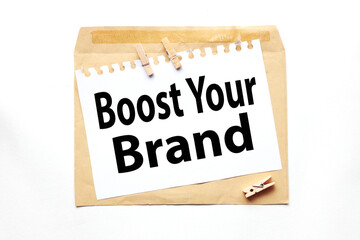 Boost Your Brand, text on paper on craft envelope on white background