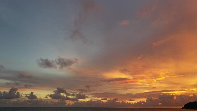 aerial view Scene of Colorful romantic sky sunset with Changing the color of the sky background. .beautiful golden sky at sunset over Pu island at Kata beach Phuket in nature and travel concept.