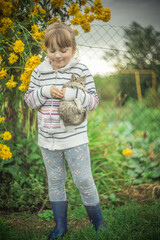 a little blonde girl with a kitten