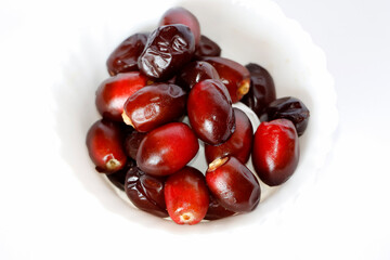 Dark Red Dates Fruit Or Date Palm In White Background. Selective Focus