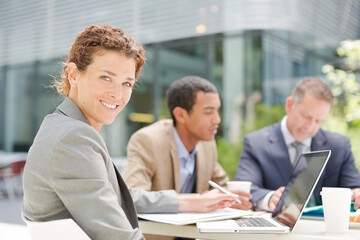Businesswoman smiling in meeting outdoors