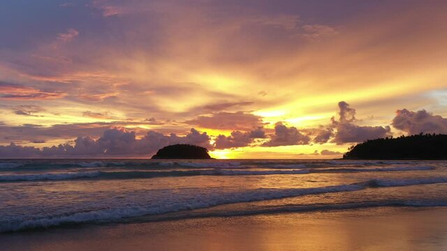 aerial view Scene of Colorful romantic sky sunset with Changing the color of the sky background. .beautiful golden sky at sunset over Pu island at Kata beach Phuket in nature and travel concept.
