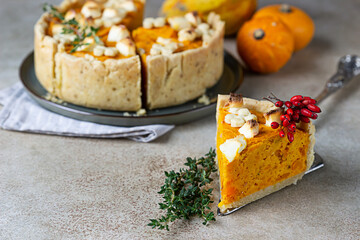 Thanksgiving Day pumpkin, feta cheese and thyme savory pie. Fall traditional homemade pumpkin pie...