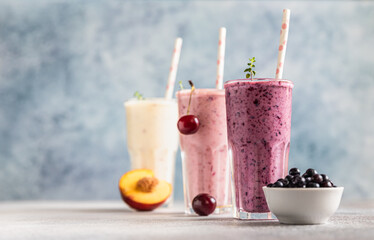 Colorful various smoothie or milkshake with assorted ingredients served in glasses with straw. Healthy food concept.