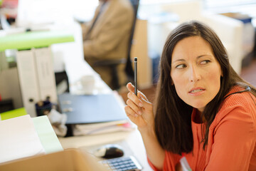 Businesswoman thinking at desk