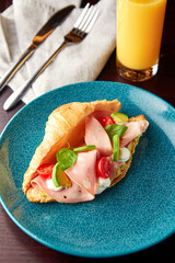 Croissant with mortadella sausage and cream cheese.