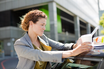 Businesswoman using tablet computer outdoors