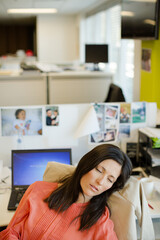 Businesswoman sleeping in chair