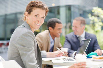 Fototapeta premium Businesswoman smiling in meeting outdoors