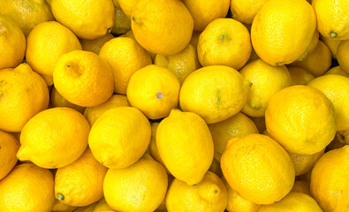 Lemons on the market. Lemon background. Vegan background.