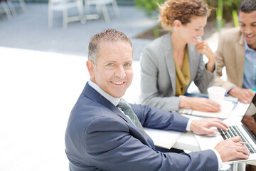 Fototapeta premium Businessman smiling in meeting outdoors