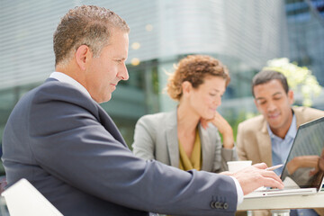 Business people talking in meeting outdoors