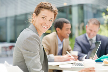 Fototapeta premium Businesswoman smiling in meeting outdoors