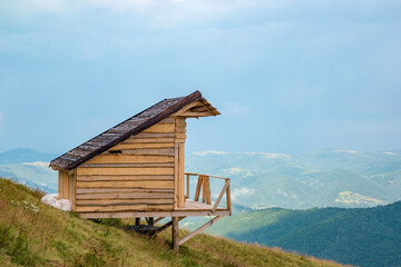 Wooden hut cabin on the Yavirnyk meadow in the Carpathians
