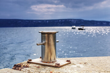 Fototapeta premium metal bollard on a pier of a marina on cres island