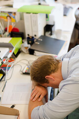 Businessman resting head on desk