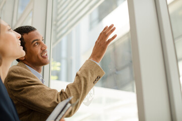 Business people talking in office next to window