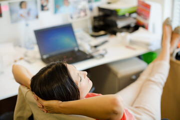 Businesswoman relaxing at desk