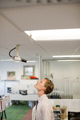 Businessman examining security camera in office
