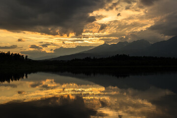 Sunset over the lake and High Tatras mountains, Slovakia. Popular fishing spot and public beach near Svit town.