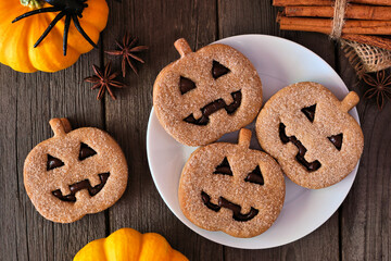 Plate of Halloween Jack o Lantern cookies. Chocolate and pumpkin spice. Top view with decor on a...