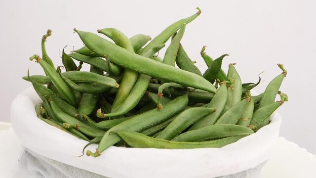 Close shot oif white back filled with green beans