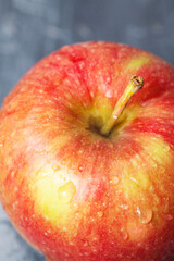 Drops of water on an apple. Macro photography of fruits. Close-up of an apple. Fresh harvest. Vegan food