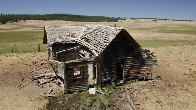 Aerial: Abandoned haunted farm house on a ranch, Ukiah, Oregon, USA
