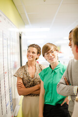 Business people reading blueprints in meeting